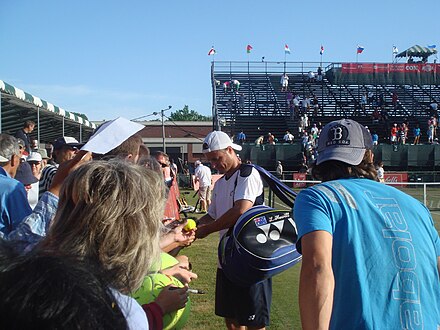 Lleyton Hewitt signing autographs after dismissing Vasek Pospisil 6–1 6–1 in the first round of the Hall of Fame Tennis Championships in Newport in 2012.