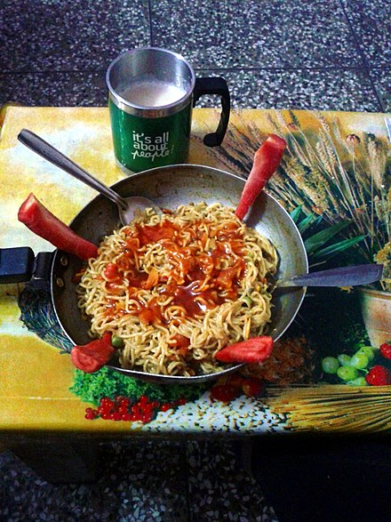 Boiled Maggi instant noodles with tea, served in India.