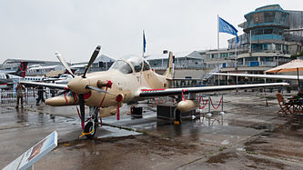 English: Mauritania Air Force Embraer A-29B Super Tucano (reg. 5T-MAW, c/n 192) at Paris Air Show 2013. Deutsch: Embraer A-29B Super Tucano (Reg. 5T-MAW, c/n 192) der mauretanischen Luftwaffe auf der Paris Air Show 2013.