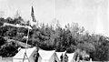 Men from Alaska Engineering Commission survey party standing in front of tents at Camp No 2, near village of Knik, Alaska, June (AL+CA 3459).jpg