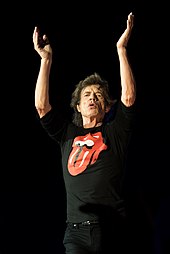 Mick Jagger wearing the tongue and lips logo t-shirt Mick Jagger onstage in Warsaw 2018.jpg