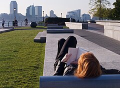 A woman reading in the Battery Park. New York City 2005