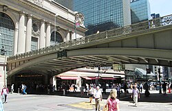 The viaduct over 42nd Street, spanning Pershing Square. Underneath, the green sign in the center of the bridge says "Pershing Square". Grand Central Terminal is on the center and left.