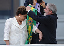 Former president Lula da Silva passes the presidential sash to Rousseff at parlatorium (speaker's platform) of the Planalto Palace. Posse Dilma 2010 8.jpg