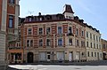 Apartment building with shops in a corner and closed development