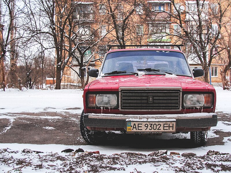 File:Red car in a snowy lot (Unsplash).jpg
