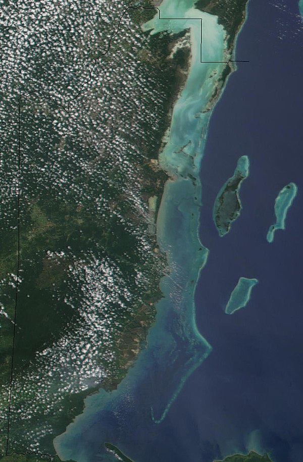 The Barrier Reef is clearly visible along the eastern coast of Belize in the Caribbean Sea.