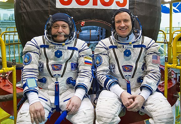 Soyuz MS-04 crew in front of their spacecraft.jpg