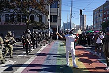 A standoff between police and protesters at a rainbow crosswalk on Capitol Hill Standoff between SPD and Protestors (50153355163).jpg