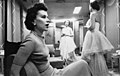 Stanley Kubrick, woman seated as other woman models clothes cph.3d02343.jpg