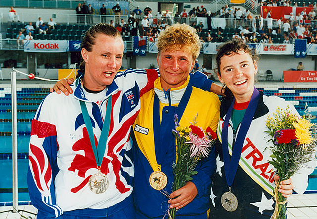 Eila Nilsson of Sweden celebrating her 50 m freestyle B1 gold with Janice Burton of Great Britain and Tracey Cross of Australia.