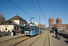 The tram station at Aker brygge with an SL79 tram. Trikkestopp radhusbrygga.jpg