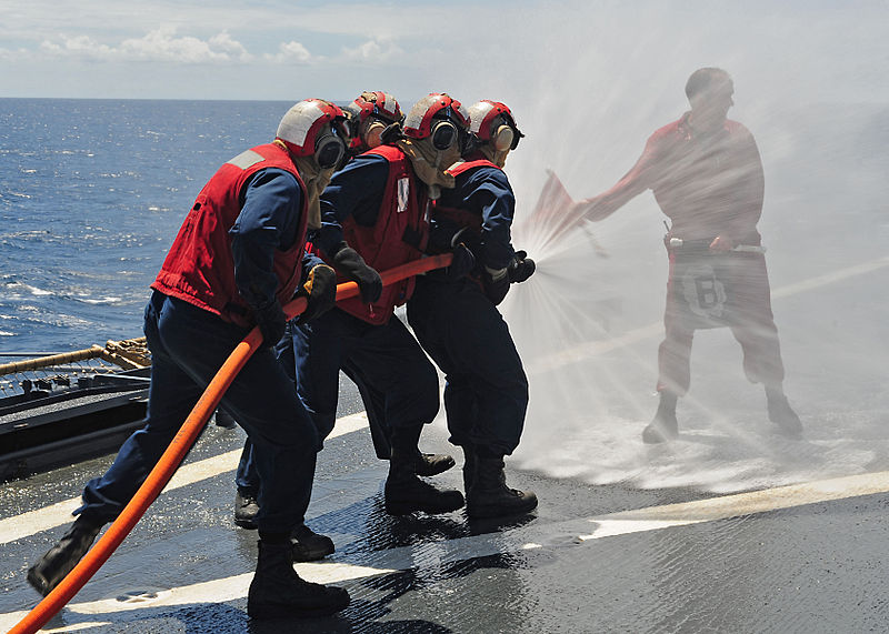 File:U.S. Navy Damage Controlman 1st Class Daniel O'Connor, right, holds up a flag indicating a fire during a general quarters drill aboard amphibious dock landing ship USS Gunston Hall (LSD 44) in the Atlantic Ocean 120414-N-XO436-063.jpg