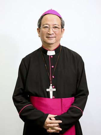 Archbishop Paul Bùi Văn Đọc of Vietnam wearing Pope Francis' Good Shepherd pectoral cross suspended by a chain while in cassock