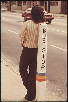 A person waiting at a MARTA bus stop, June 1974 BUS STOP IS A LEANING POST FOR A PASSENGER WAITING FOR A METROPOLITAN ATLANTA RAPID TRANSIT AUTHORITY (MARTA) BUS IN... - NARA - 556799.jpg