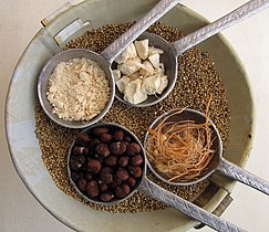 Elements of the fruit pulp of Adansonia digitata (clockwise from top right): whole fruit pulp chunks, fibers, seeds, powder from the pulp