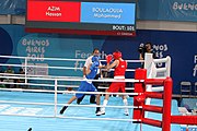 Deutsch: Boxen bei den Olympischen Jugendspielen 2018 Tag 12, 18. Oktober 2018 - Kampf um Bronze im Leichten Weltergewicht Jungen – Hassan Azim (Großbritannien, rot) schlägt Mohammed Boulaouja (Marokko, blau) RSC; Ringrichter ist Wulfren Olivares Peréz (Kolumbien). English: Boxing at the 2018 Summer Youth Olympics on 18 October 2018 – Bronze Medail Match Light Welterweight Boys - Hassan Azim (Great Britain, red) beats Mohammed Boulaouja (Morocco, blue) RSC; Referee is Wulfren Olivares Peréz (Columbia). Español: Boxeo en los Juegos Olímpicos Juveniles de Verano de 2018 en 18 de octubre de 2018 - Medalla de bronce de los hombres ligeros de peso welter: Hassan Azim (Gran Bretaña, rojo) vence a Mohammed Boulaouja (Marruecos, azul) RSC; El árbitro es Wulfren Olivares Peréz (Colombia).