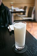 A glass of a coconut-based drink.