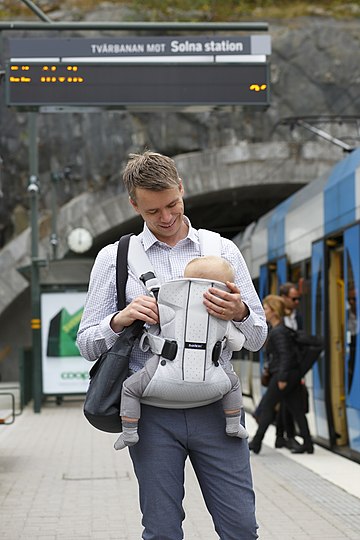 A young father with a baby in Stockholm, Sweden (2015).