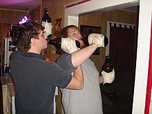 Drinking game "Edward Fortyhands", where bottles of beer are taped to participants' hands Edward Fortyhands.jpg