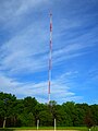 Soccer field with antenna tower across the river in the background