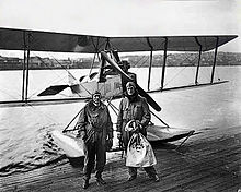 Eddie Hubbard (left) and William E. Boeing stand in front of a Boeing C-700 seaplane near Seattle. First international Airmail flight, 1919.jpg