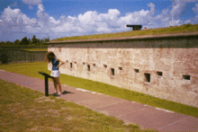 A tourist reads an informative plaque inside the Fort structure. August 2002 Foma2.gif