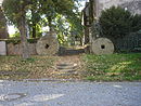 Lindenstrasse, in front of the church;  two woad millstones 002.JPG