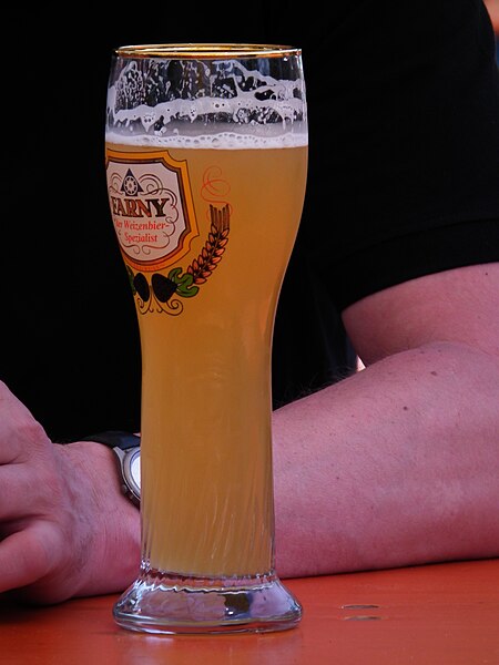 A glass of beer with the head having receded, leaving behind noticeable lacing