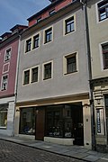 Residential house in closed development and side wing in the courtyard