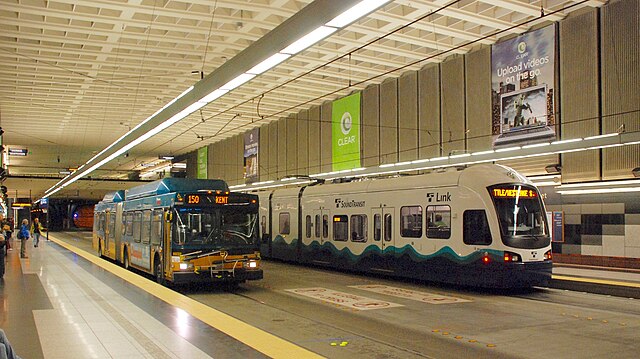 A King County Metro bus and Sound Transit Link light rail train at University Street station, during joint bus–rail operations at tunnel stations