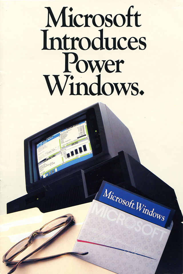 1986年1月发行的Windows 1.0宣传册封面，上方为英文「Microsoft Introduces Power Windows.」，意为「微软推出了强大的Windows」，下方印刷有一台运行着Windows 1.0的计算机、一副眼镜、一张Windows 1.0的安装软盘