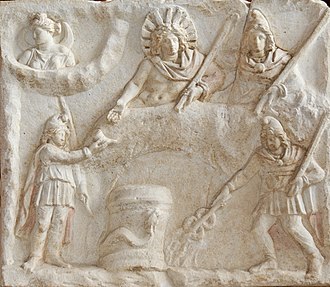 Banquet scene on the Fiano Romano Mithraic relief. At bottom are Cautes (l) and Cautopates (r). Mithras banquet Louvre Ma3441.jpg