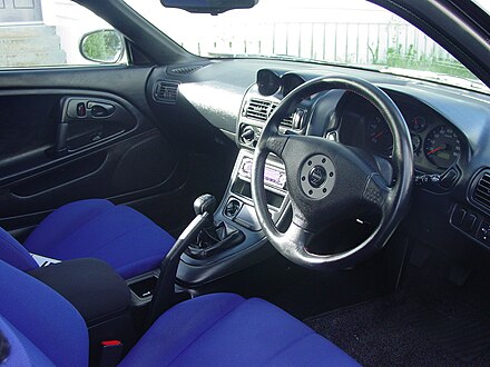 GP Version R (Scotia White) model interior with distinctive blue seats. This interior also shows the three-spoke Momo airbag wheel & manual climate control.
