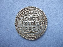 Nepalese silver mohar in the name of King Bhupatindra Malla (ruled 1696-1722) of Bhadgaon (Bhaktapur), dated Nepal Era 816 ( = AD 1696), obverse. Silver mohars of this type were also exported to Tibet where they circulated along with other Malla mohars. Nepalese mohar 816.jpg