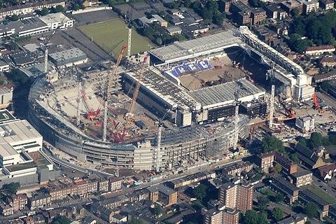 Construction of the northern section of new stadium (left) started while White Hart Lane was still in use. White Hart Lane (right) was partially demolished here in May 2017. The new ground covers part of the old ground.