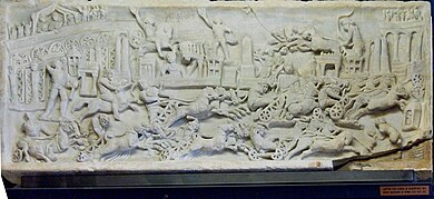 Chariot races, as depicted on this 2nd-century relief, were among the ludi presented at Roman religious festivals PalazzoTrinci026.jpg