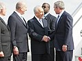 President George W. Bush is greeted by Israel’s President Shimon Peres, center, and Prime Minister Ehud Olmert.jpg