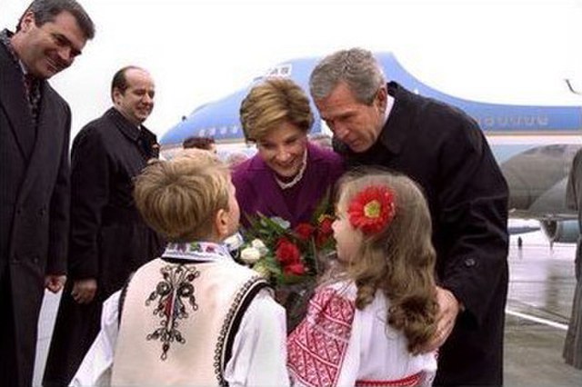 Romanian children greet President and Mrs. Bush upon their landing in Bucharest, 2002