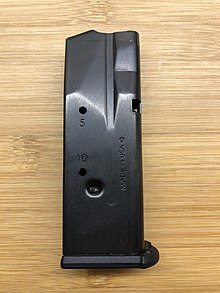 A magazine for a SIG Sauer P365 XL, modified by the manufacturer to limit capacity to 10 rounds, rather than its full 12 rounds. Capacity is limited by the crimp seen slightly below the 10-round witness hole, for compliance with the high-capacity magazine ban in Massachusetts. SIG Sauer P365 limited capacity magazine.jpg