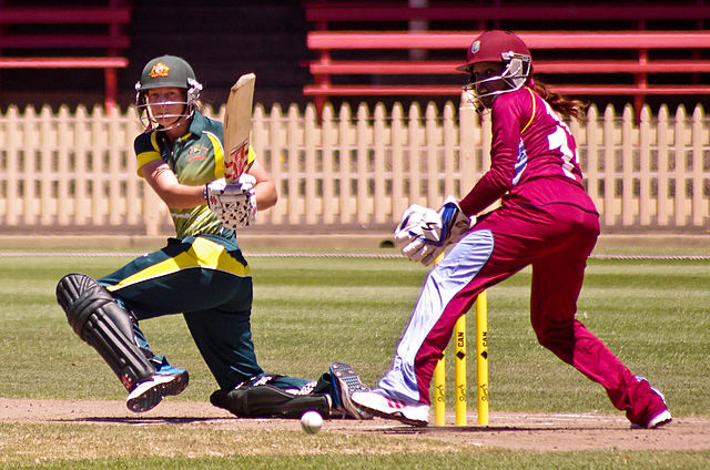 Australian batter Meg Lanning plays a sweep shot while Merissa Aguilleira of the West Indies keeps wicket during the 2014 West Indies tour of Australi