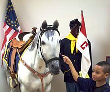 A child examines the Buffalo Soldiers display in the Black Veterans section of the Tangipahoa African American Heritage Museum. Tangipahoa African American Buffalo soldiers 2010Jan18.jpg