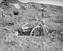 A 4.5-inch howitzer dug into a shellhole on the Western Front. The Battle of the Somme, July-november 1916 Q4414.jpg