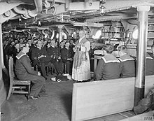 A Roman Catholic priest with a full-length lace alb holding Mass on one of the mess decks in HMS Royal Oak during the First World War. The Royal Navy during the First World War Q18008.jpg