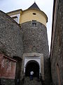 Partly reconstructed corner tower seen with entrance.