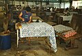 Worker printing resist on to Batik cloth with a Tjap