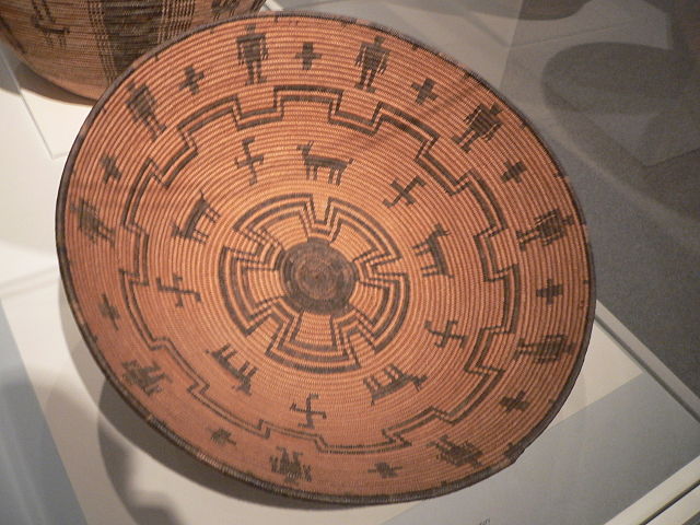 An early 20th century basket bowl woven of willow and reed