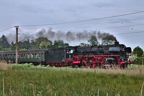 Steam locomotive at full speed passing Loppersum, Germany.