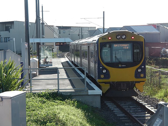 ADL 810 diesel unit at Onehunga Railway Station, with electrification infrastructure partially installed