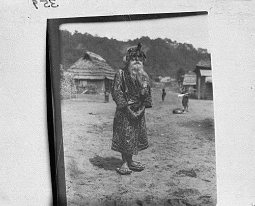 File:Ainu chief wearing a headdress standing in the village lane LOC agc.7a10349.tif